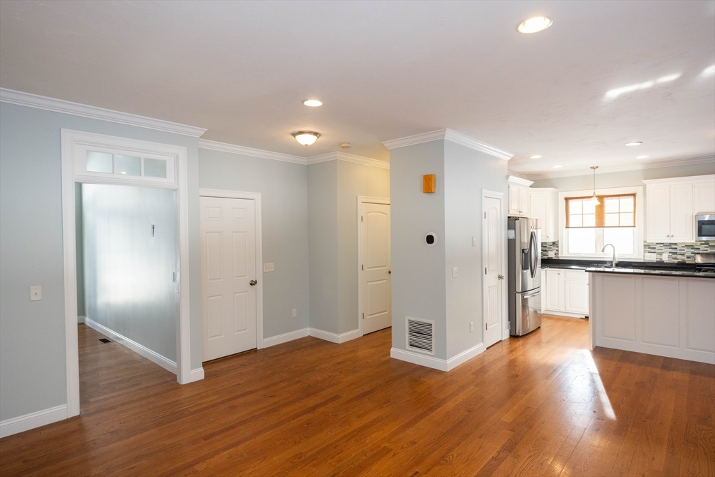 4 Cyrus Way, Unit 4 Northborough, MA 01532 - Photo 8 of 17 a view of a kitchen with a refrigerator and wooden floor