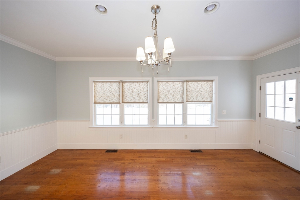 4 Cyrus Way, Unit 4 Northborough, MA 01532 - Photo 9 of 17 an empty room with wooden floor and windows