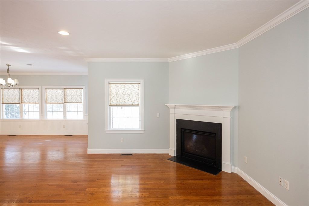 4 Cyrus Way, Unit 4 Northborough, MA 01532 - Photo 10 of 17 a view of an empty room with wooden floor and a window