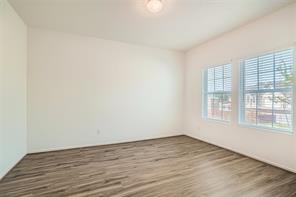 700 Mallow Road Leander, TX 78641 - Photo 14 of 28 Gleaming wood-look floors and generous windows create an inviting, versatile blank canvas.