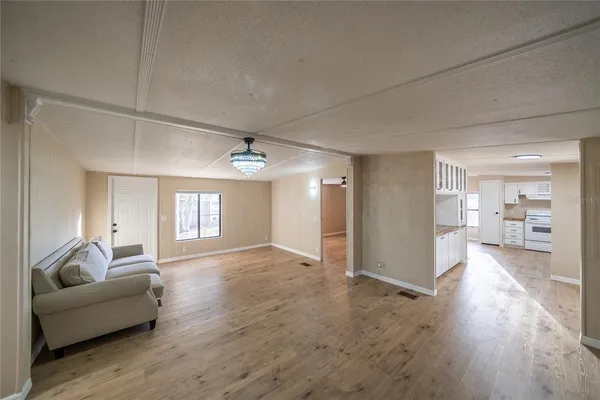 wooden floor in an empty room with a window and wooden floor