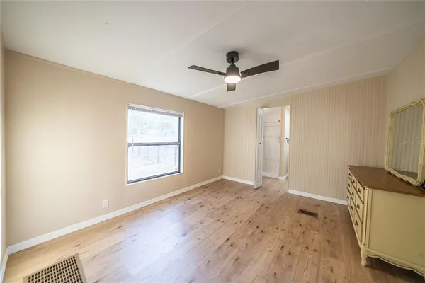 a bathroom with a granite countertop sink a toilet and a mirror