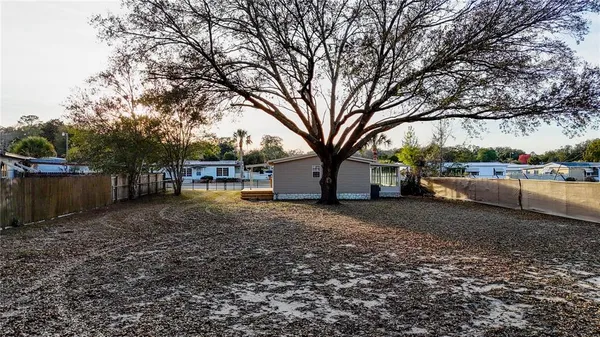 a view of a yard with a house in the background