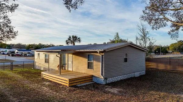 a view of a house with a window and wooden fence
