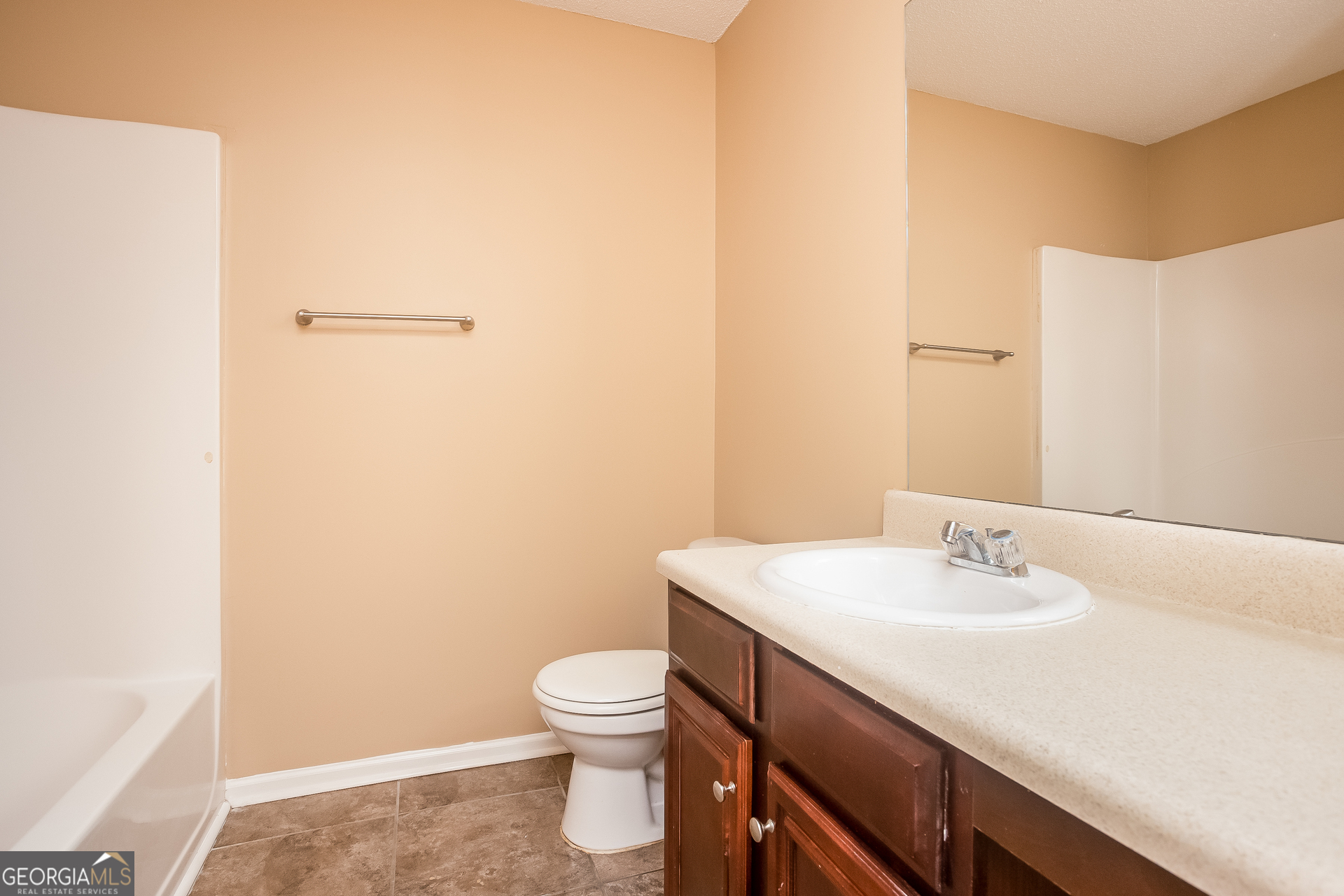 8311 Champion Trail Fairburn, GA 30213 - Photo 13 of 17 a bathroom with a sink toilet and vanity