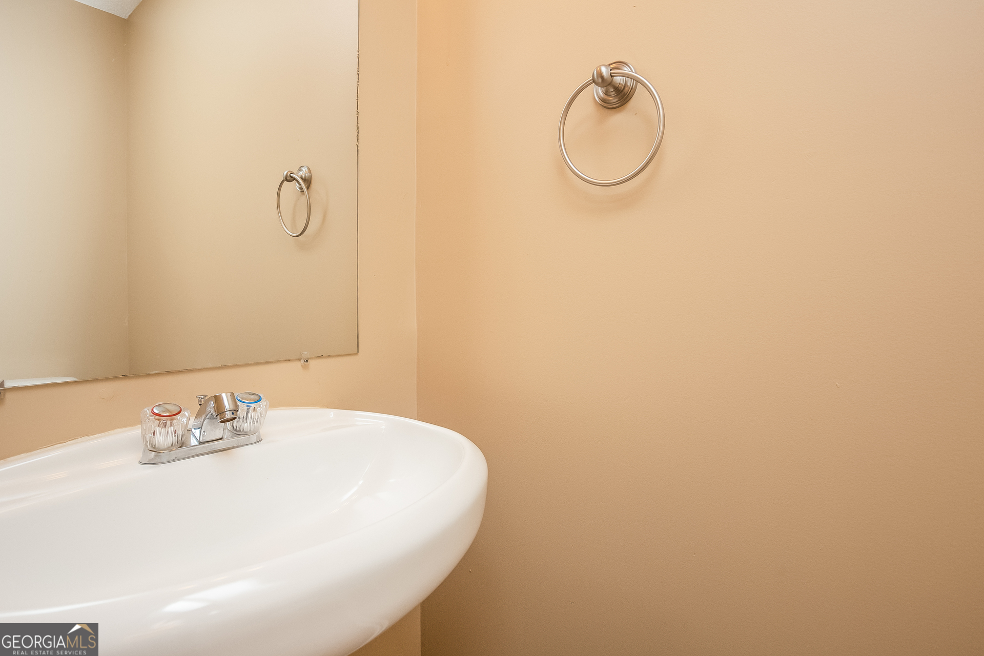 8311 Champion Trail Fairburn, GA 30213 - Photo 14 of 17 a bathroom with a sink and mirror