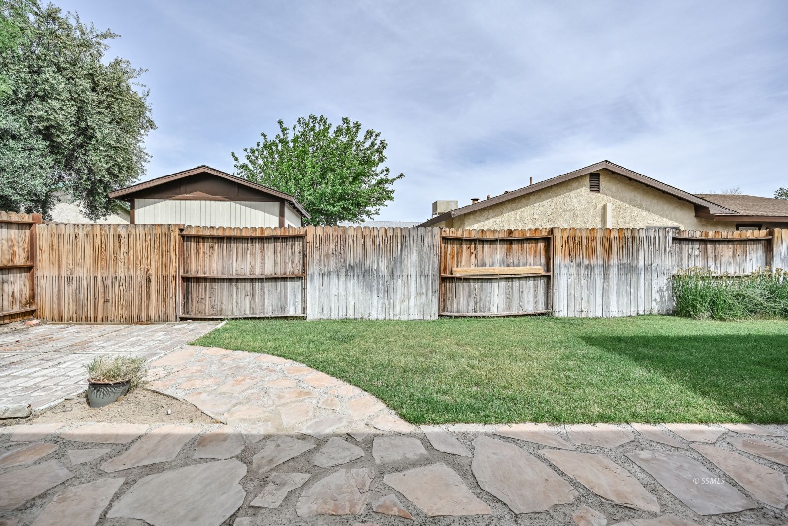 131 Chambers Street Ridgecrest, CA 93555 - Photo 23 of 28 a front view of a house with a yard and garage