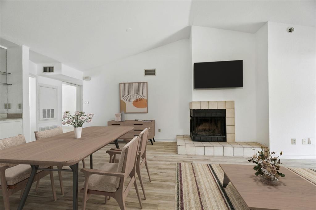 2450 Wickersham Lane, Unit 106 Austin, TX 78741 - Photo 2 of 13 a view of a dining room with furniture wooden floor and a fireplace