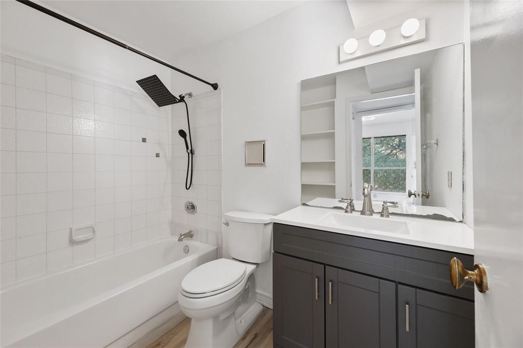 2450 Wickersham Lane, Unit 106 Austin, TX 78741 - Photo 8 of 13 a bathroom with a sink a toilet and shower