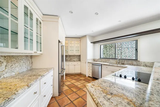 a kitchen with a stove a sink and a refrigerator