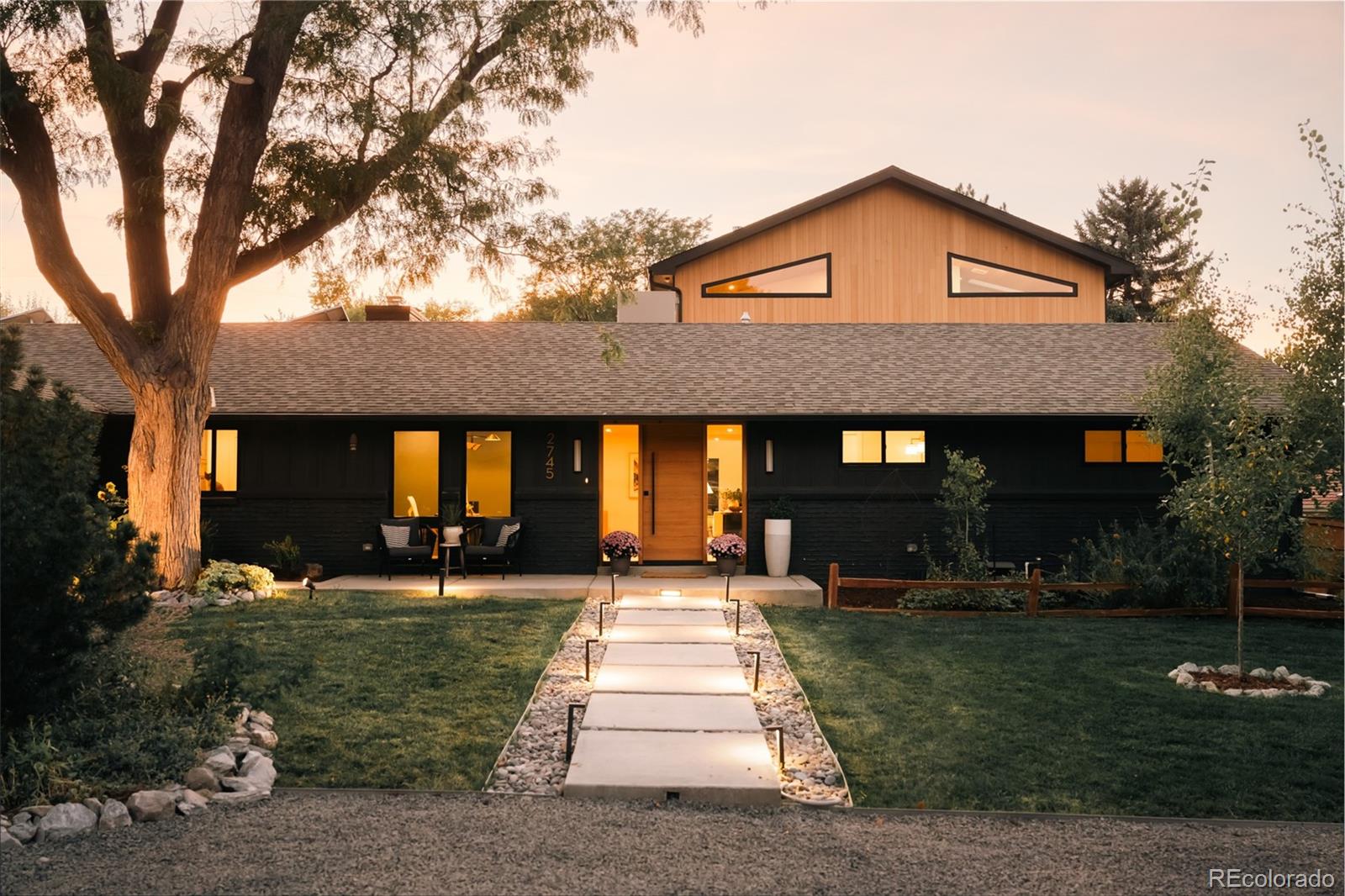 a front view of a house with a yard porch and outdoor seating