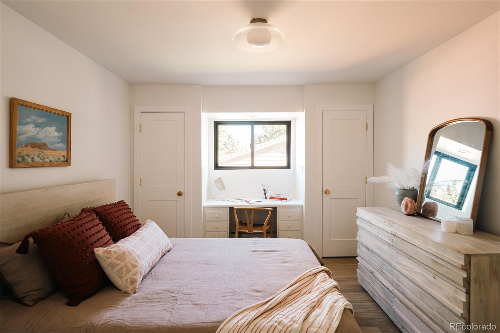2745 Deframe Road Golden, CO 80401 - Photo 15 of 50 a bedroom with a bed and a mirror