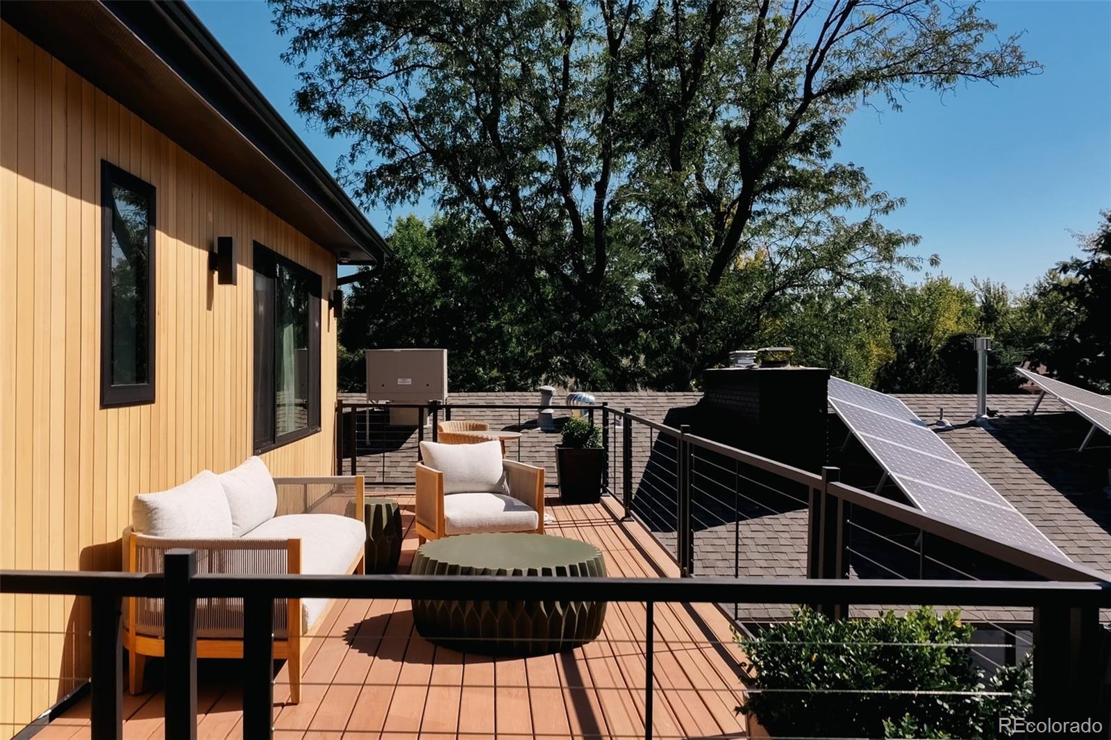 2745 Deframe Road Golden, CO 80401 - Photo 34 of 50 a view of a patio with table and chairs with wooden floor and fence