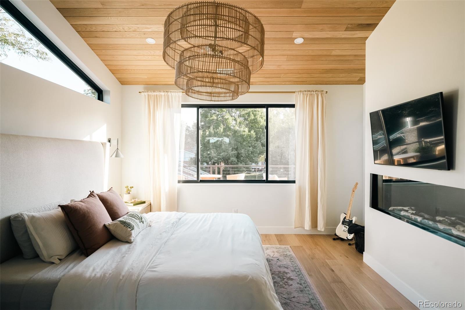 2745 Deframe Road Golden, CO 80401 - Photo 40 of 50 a bedroom with a bed and a flat screen tv