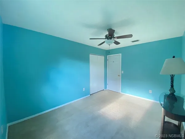 a view of a big room with fan and a ceiling fan