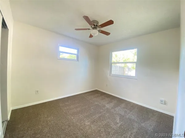 a view of a room with a ceiling fan