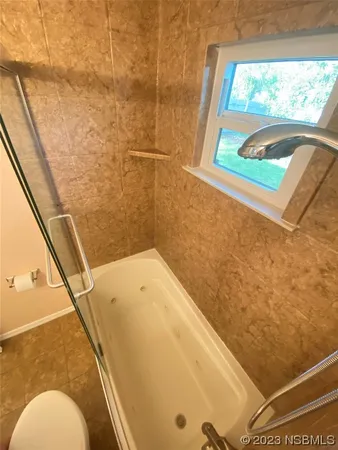 a bathroom with a shower and a glass door