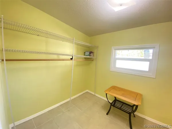 a view of a backyard that has a large tree