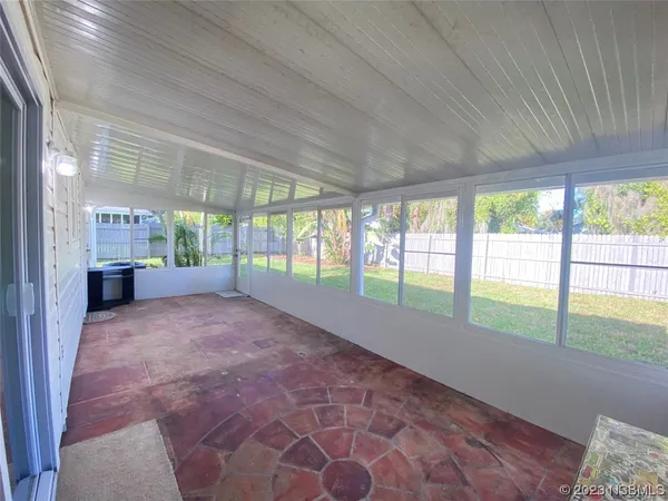 a view of house with backyard and a garden