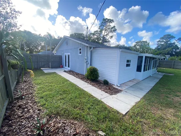 a view of backyard with small cabin