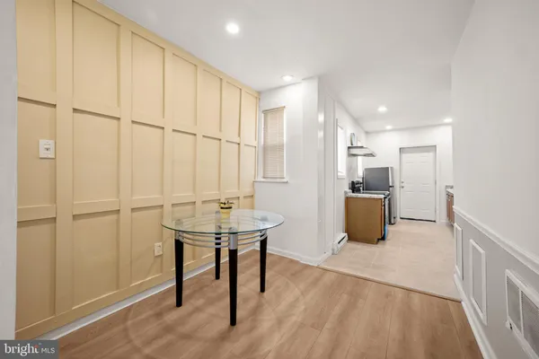 a view of a room with furniture and wooden floor