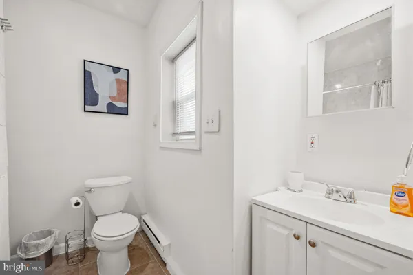 a white toilet sitting next to a bathroom sink