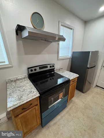 a kitchen with granite countertop a stove and a sink