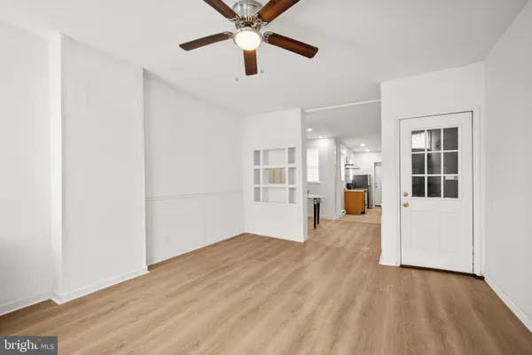 a view of empty room with wooden floor and windows