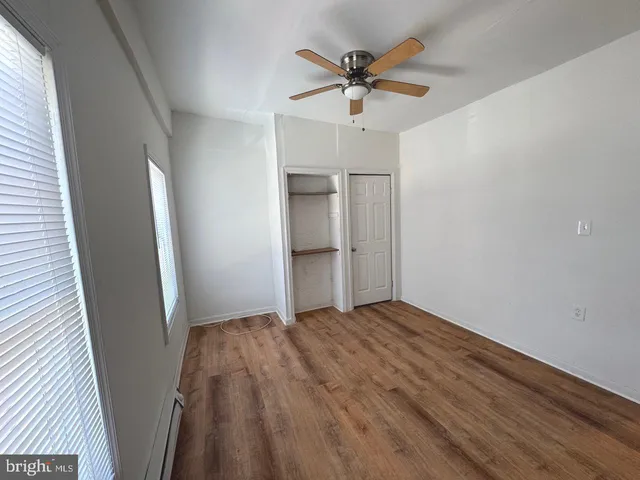 a view of wooden floor and cabinet in a room