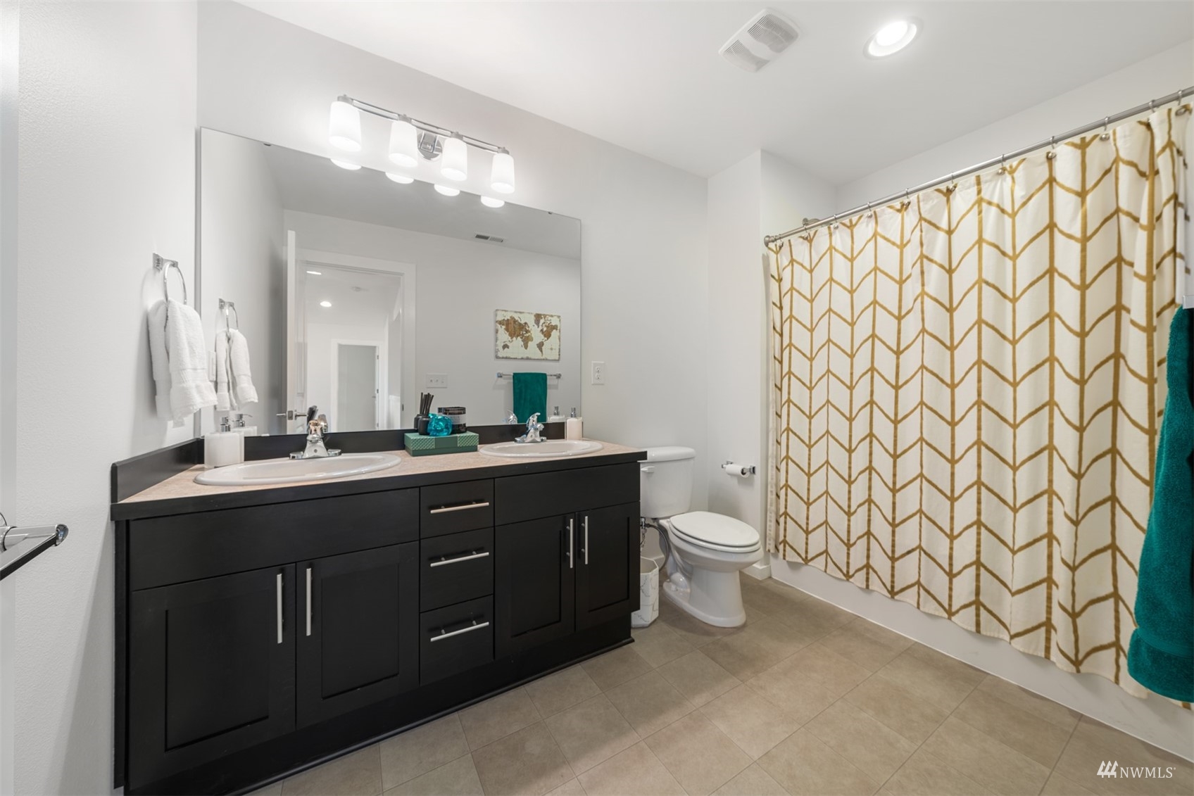 1413 South 28th Street Renton, WA 98055 - Photo 16 of 20 a bathroom with a double vanity sink toilet and a mirror