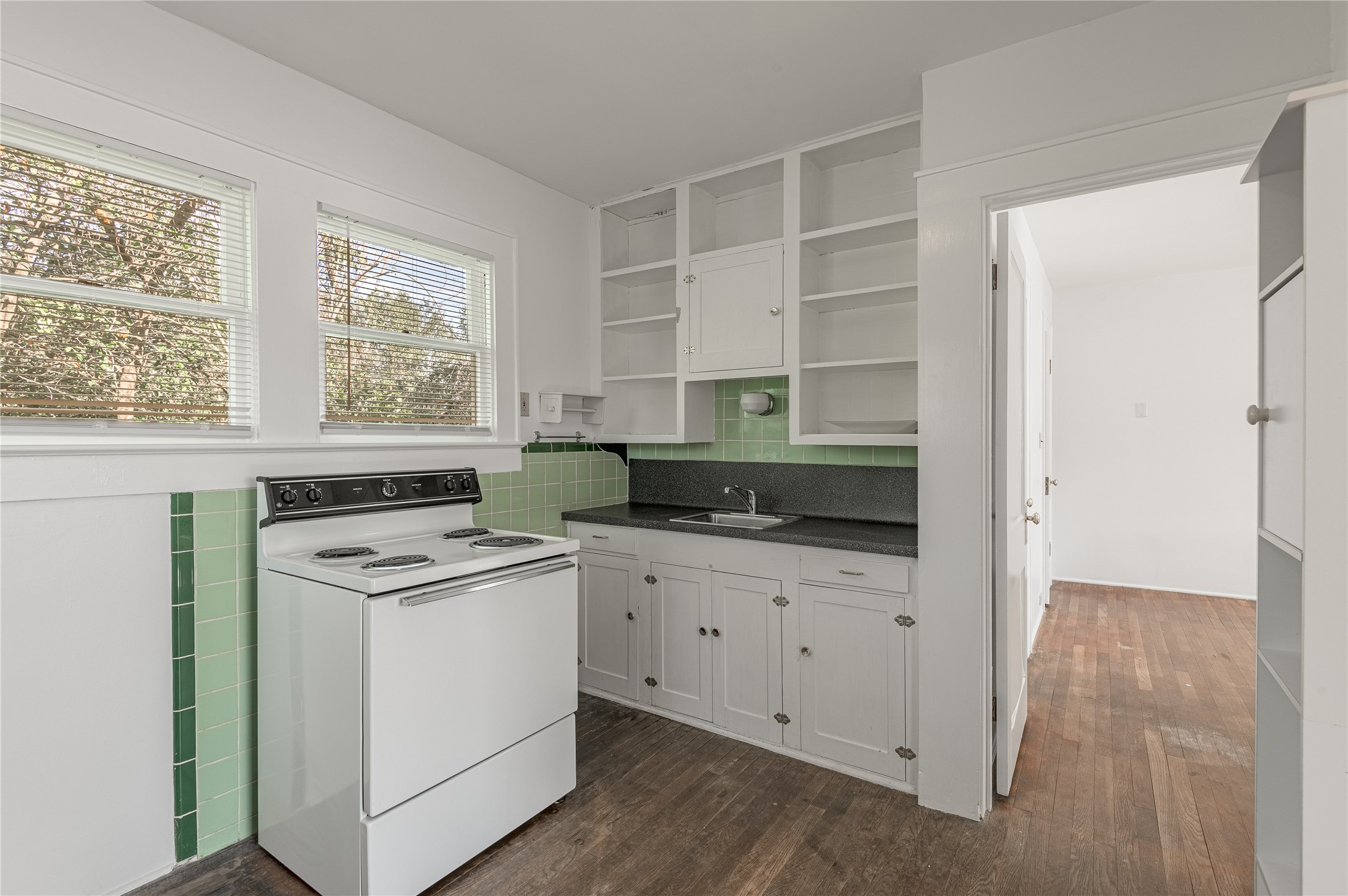 1312 20th Street, Unit GA Huntsville, TX 77340 - Photo 6 of 11 a kitchen with white cabinets and white appliances