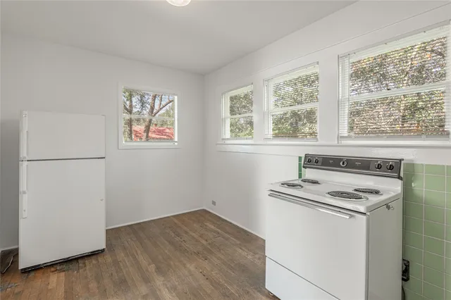 a kitchen with a stove and a refrigerator