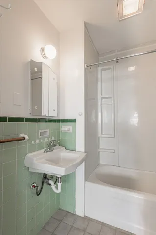 a bathroom with a sink a mirror and a bathtub