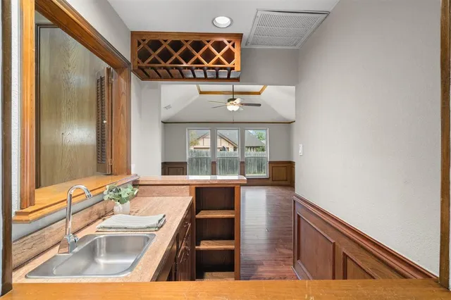 a spacious bathroom with a granite countertop sink and a mirror