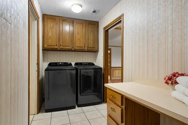 a view of a swimming pool with lawn chairs under an umbrella