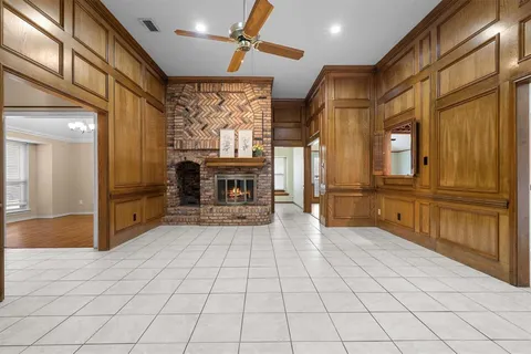 a view of a refrigerator in kitchen and an empty room