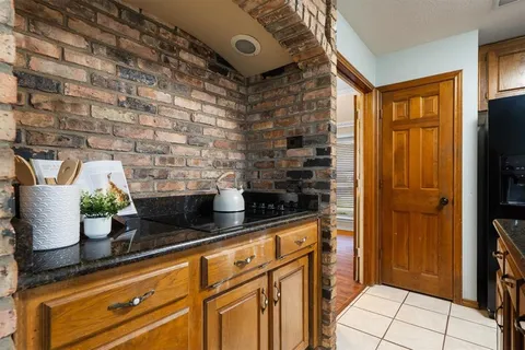 a kitchen with stainless steel appliances granite countertop a refrigerator and a stove