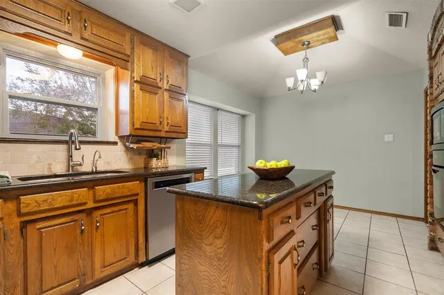 a view of empty room with window and ceiling fan