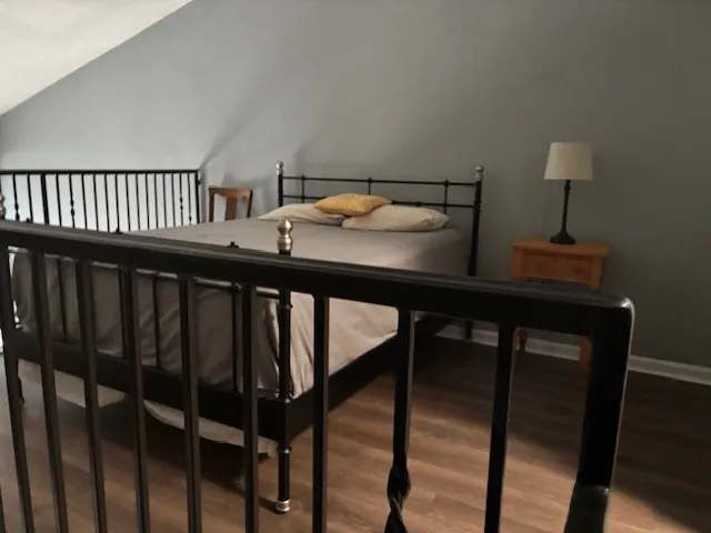 a view of staircase with wooden floor