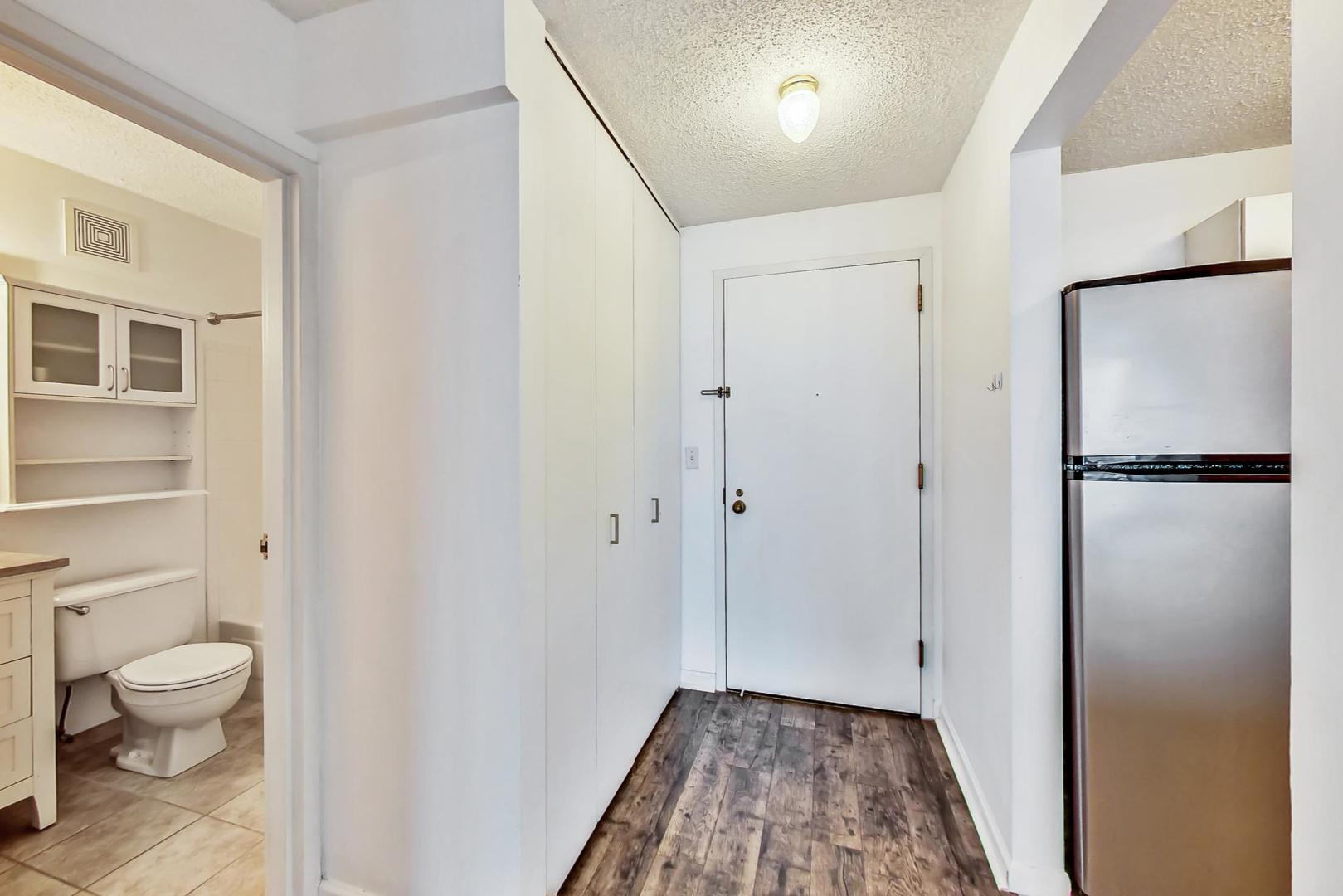 111 West Maple Street, Unit 1410 Chicago, IL 60610 - Photo 15 of 41 a view of bathroom with a toilet a sink and a mirror