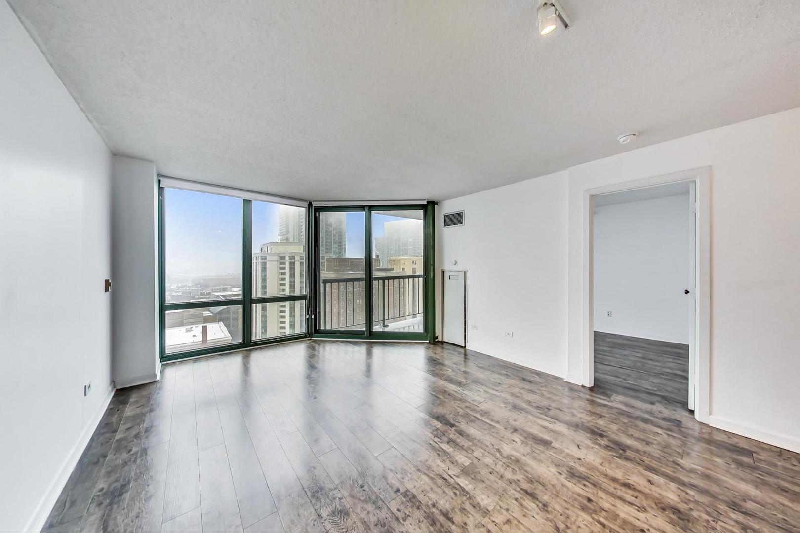 111 West Maple Street, Unit 1410 Chicago, IL 60610 - Photo 17 of 41 wooden floor in an empty room with a window