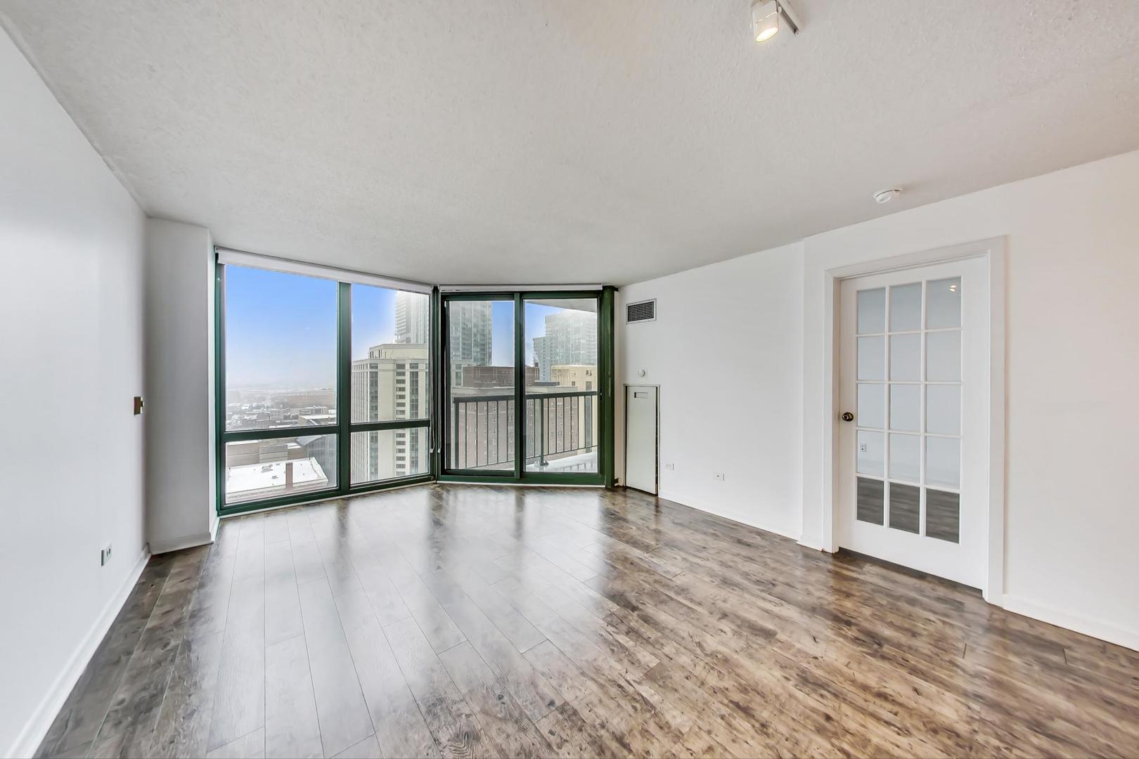 111 West Maple Street, Unit 1410 Chicago, IL 60610 - Photo 18 of 41 wooden floor in an empty room with a window