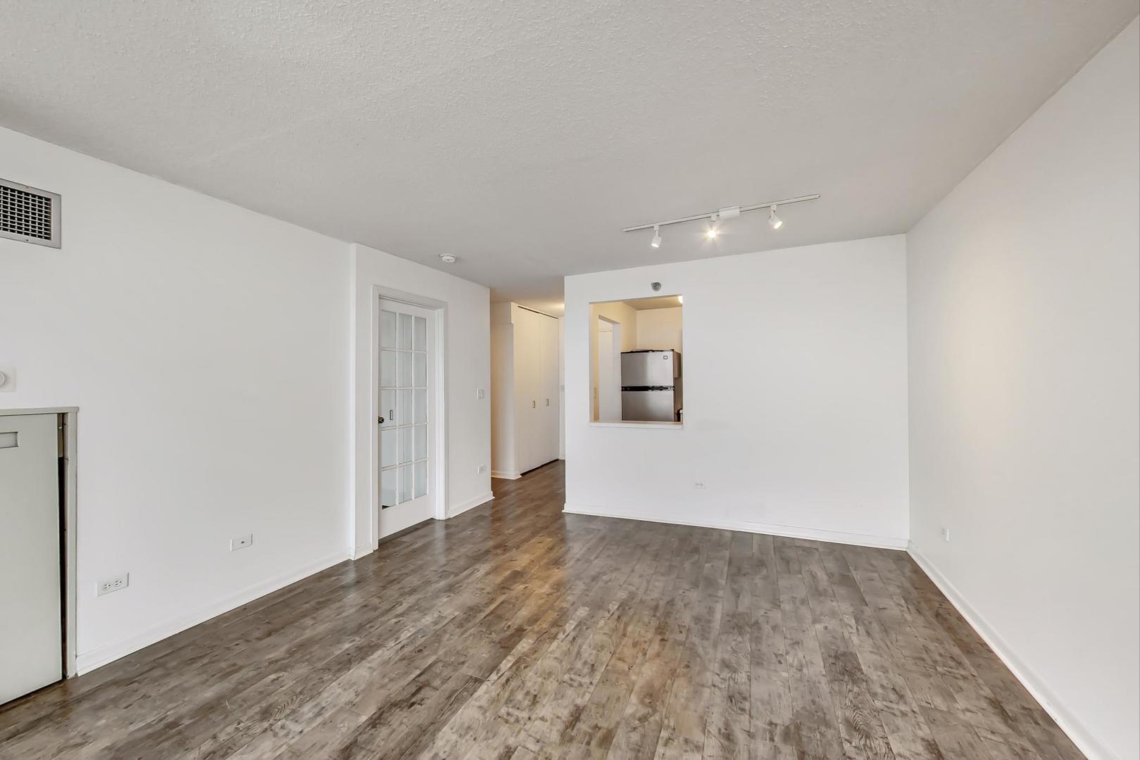 111 West Maple Street, Unit 1410 Chicago, IL 60610 - Photo 22 of 41 a view of empty room with wooden floor
