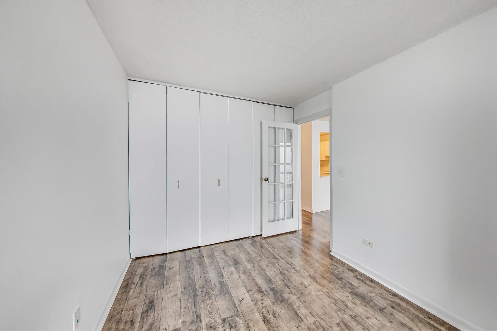 111 West Maple Street, Unit 1410 Chicago, IL 60610 - Photo 28 of 41 a view of an empty room and wooden floor
