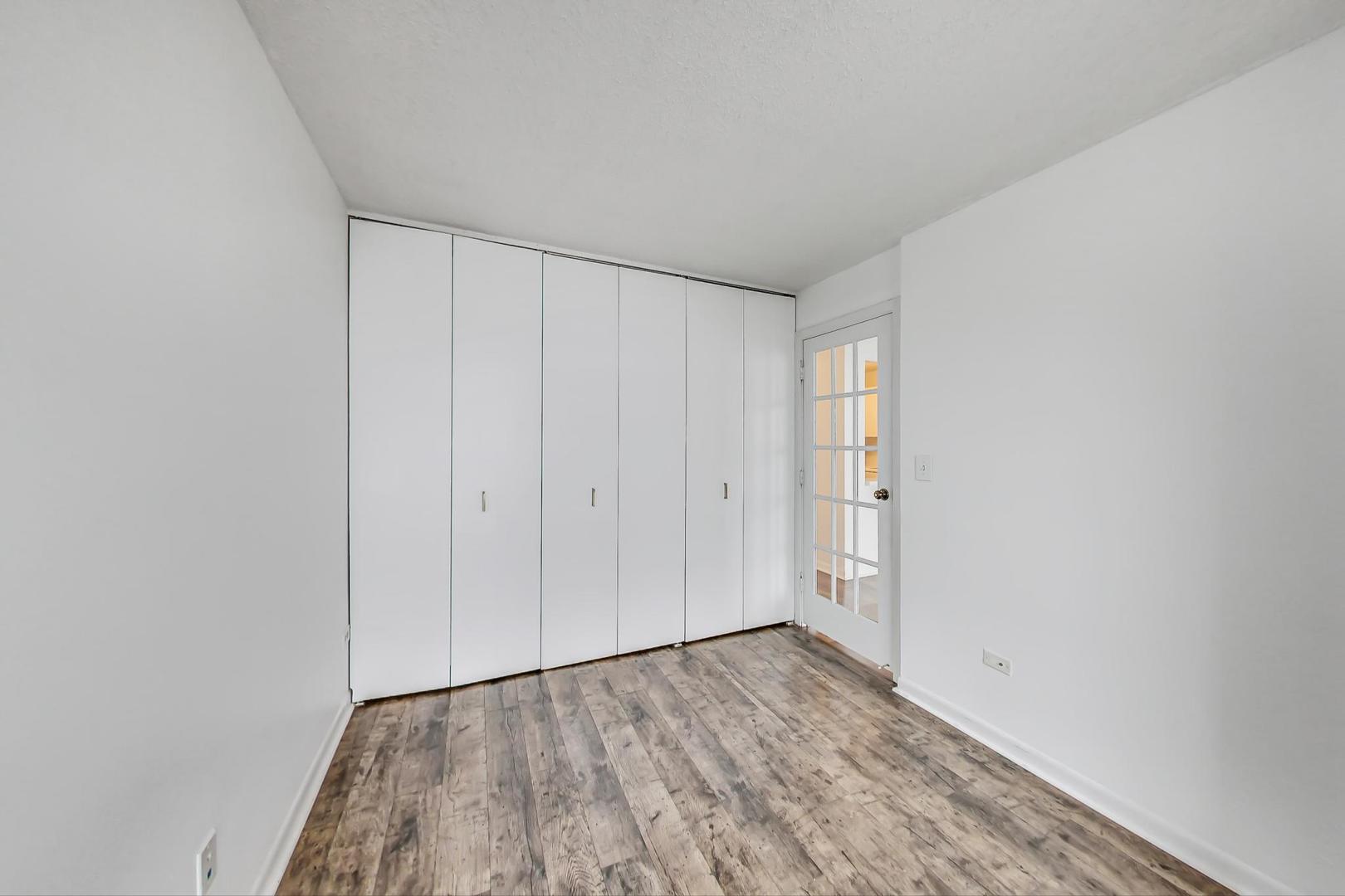 111 West Maple Street, Unit 1410 Chicago, IL 60610 - Photo 29 of 41 a view of an empty room and wooden floor