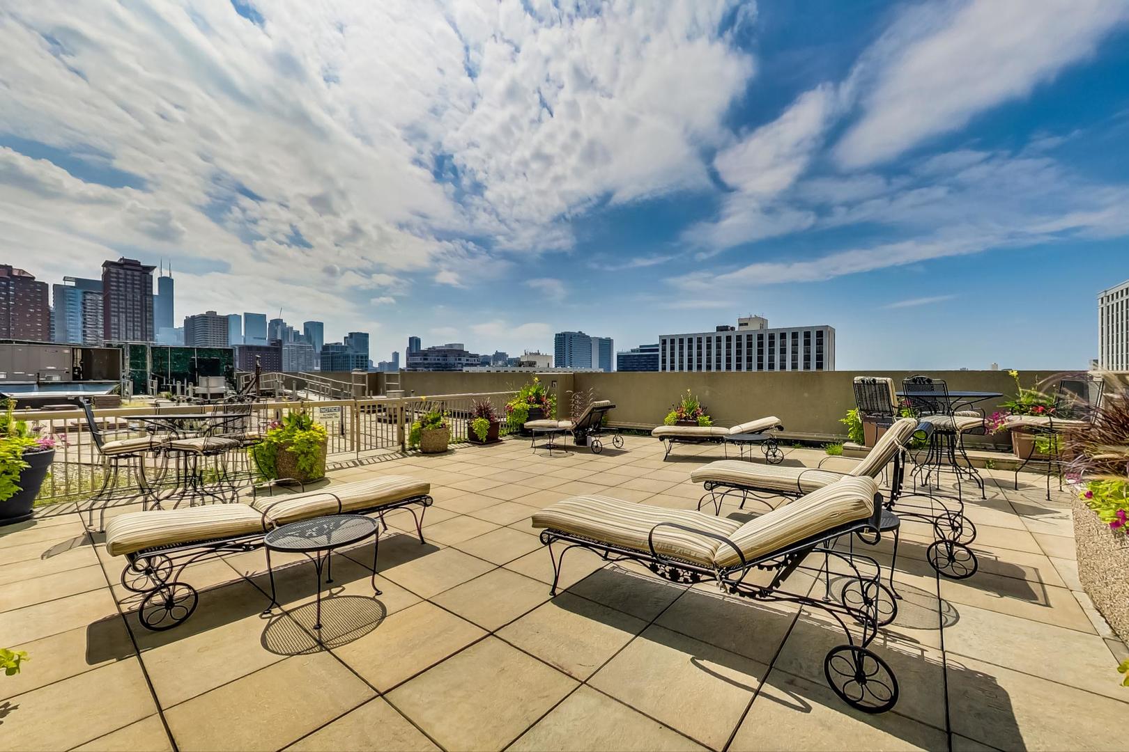111 West Maple Street, Unit 1410 Chicago, IL 60610 - Photo 35 of 41 a view of a terrace with furniture and city view