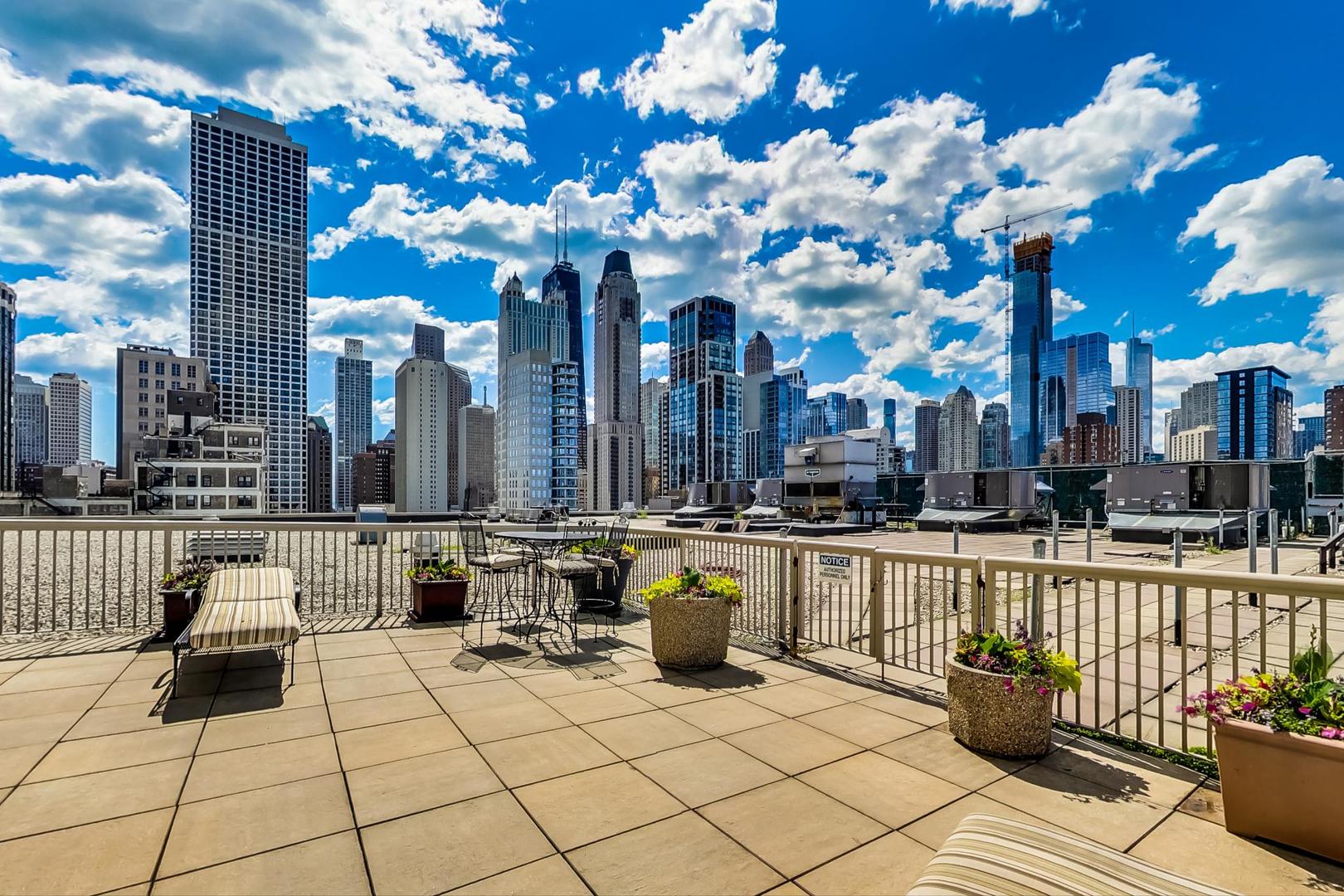 111 West Maple Street, Unit 1410 Chicago, IL 60610 - Photo 36 of 41 a view of a patio with couches and potted plants