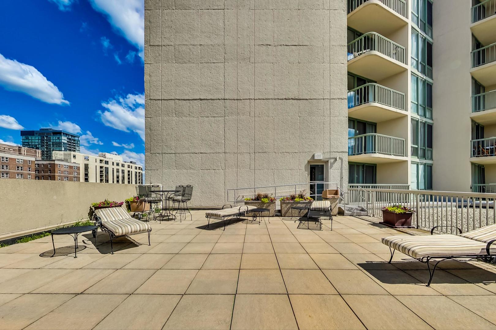111 West Maple Street, Unit 1410 Chicago, IL 60610 - Photo 37 of 41 a group of cars parked in front of building