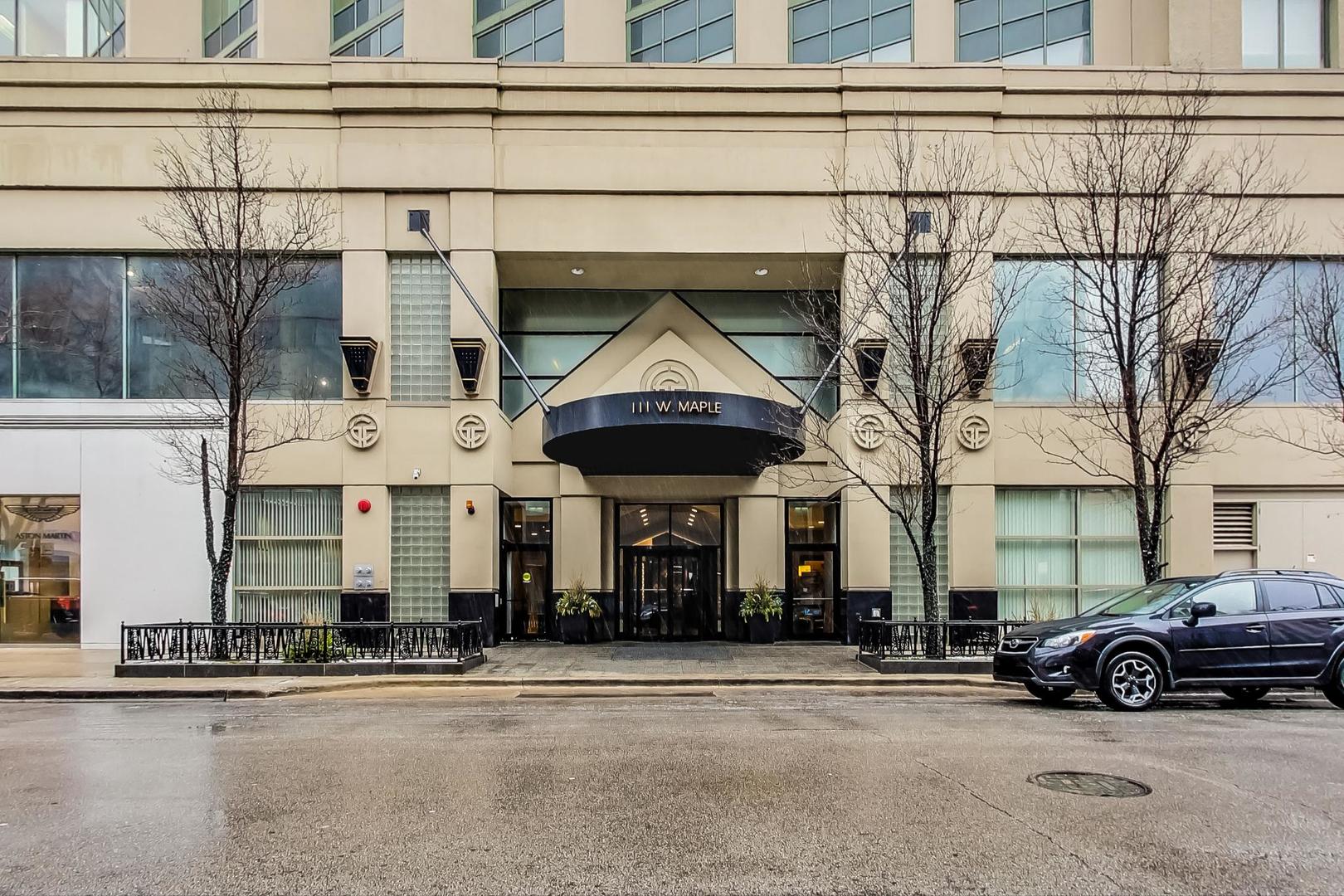 111 West Maple Street, Unit 1410 Chicago, IL 60610 - Photo 8 of 41 front view of a house with a cars