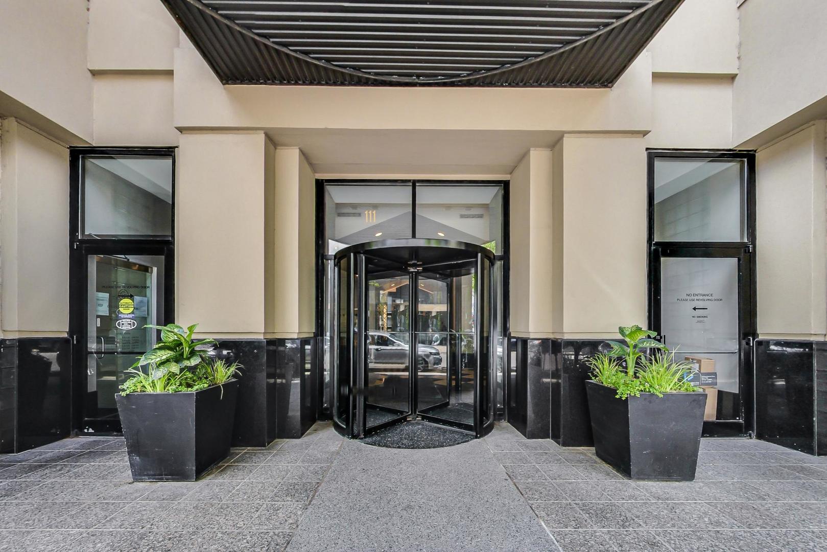 111 West Maple Street, Unit 1410 Chicago, IL 60610 - Photo 9 of 41 a front view of a house with potted plants
